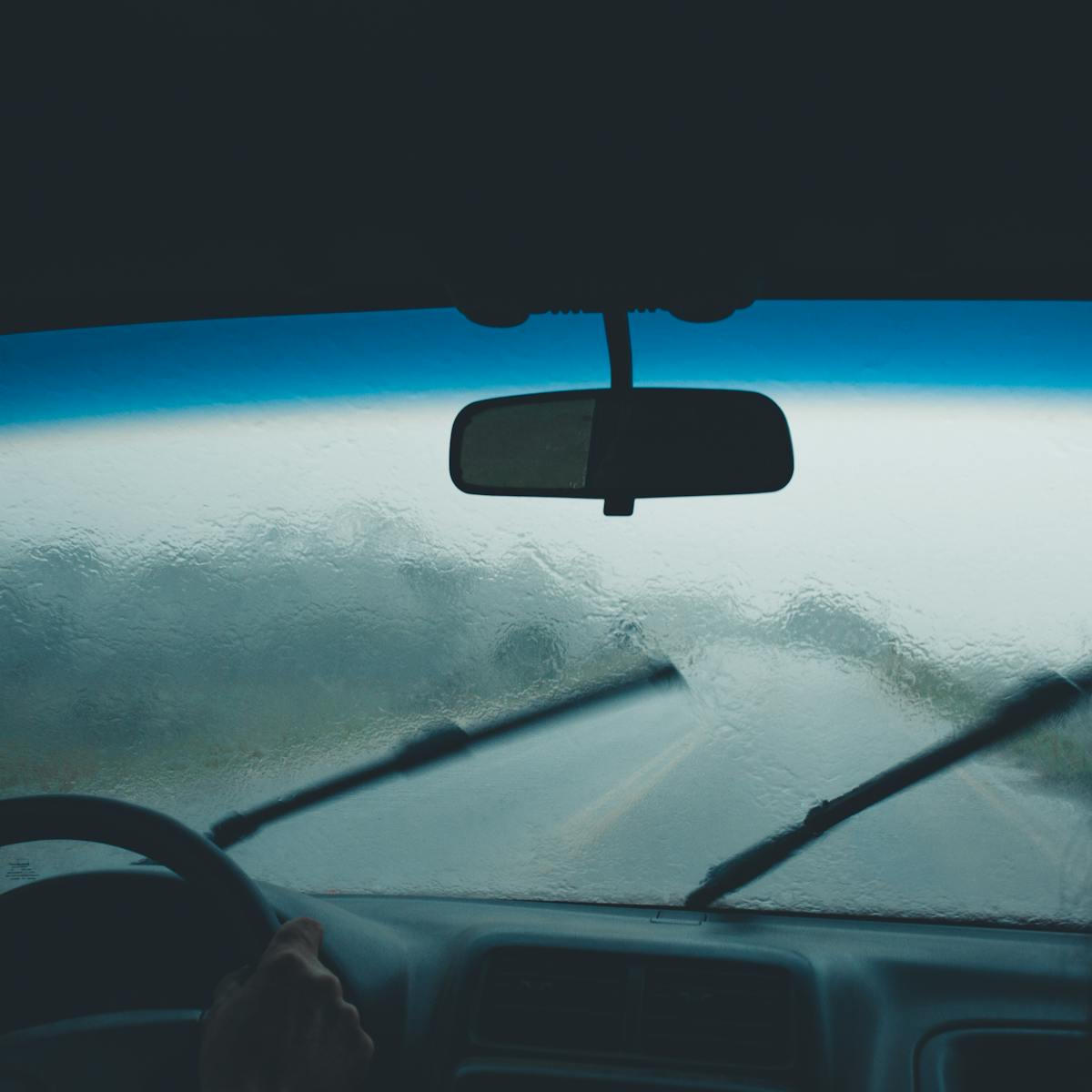 Rainy windshield with wipers in motion