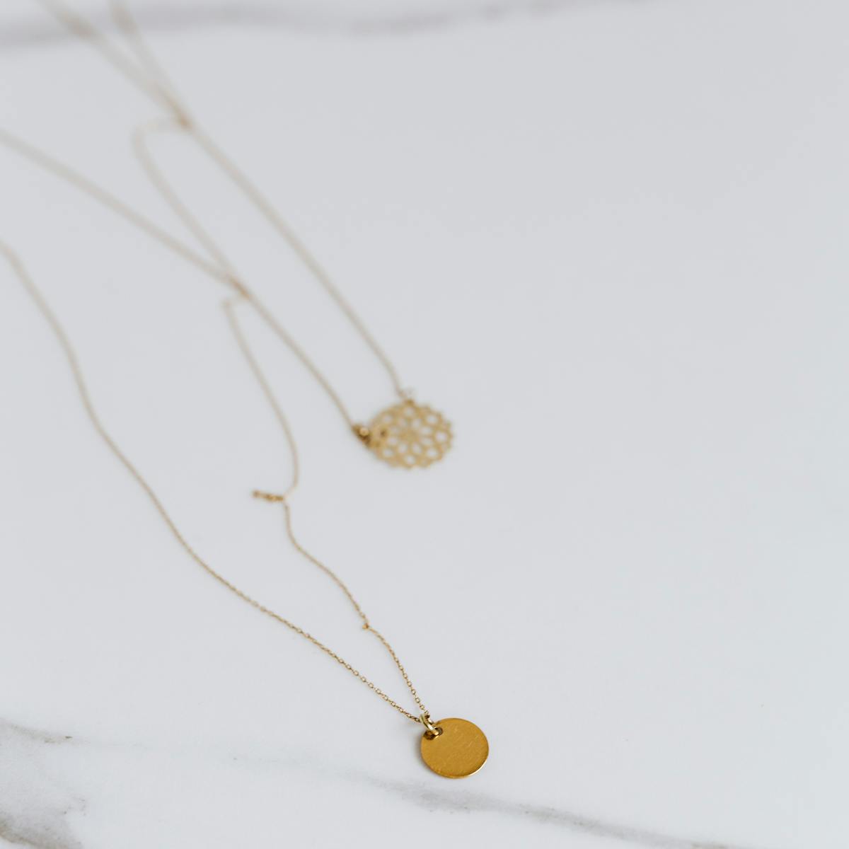 Gold jewelry on marble surface