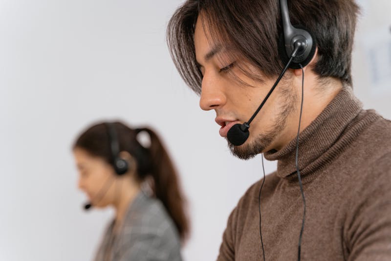 Call center employees with headsets providing support