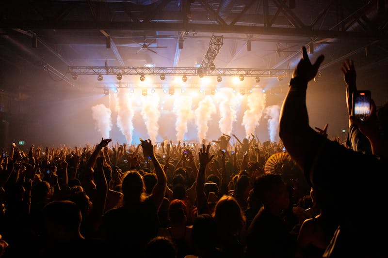 Energetic crowd at concert with dynamic lighting