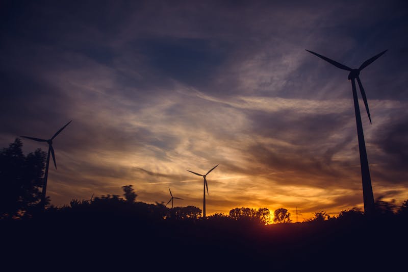 Wind turbines silhouetted at sunset